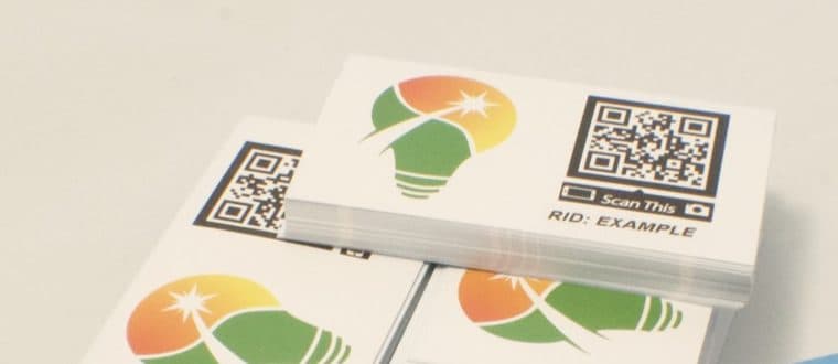 Stacks of printed Solar Strive cards, each showing the bulb mark beside a scannable QR code.